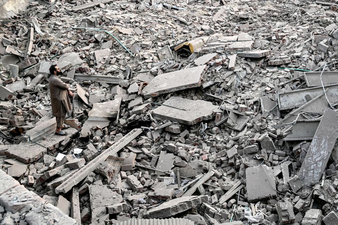 Locals stand on the debris of destroyed structures at the Government Health and Educational complex in Muridke about 30 kilometres from Lahore, Pakistan on May 7, after Indian strikes.